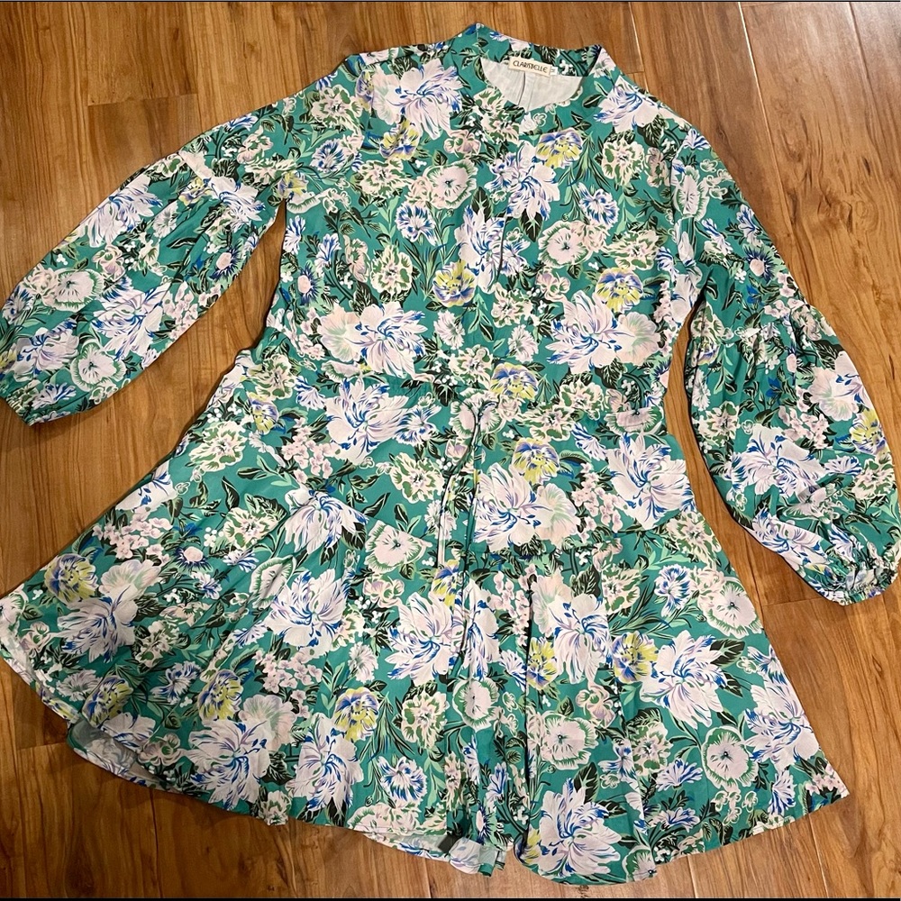 Cute Floral puff sleeve mini dress with a tie waist and button up top.
